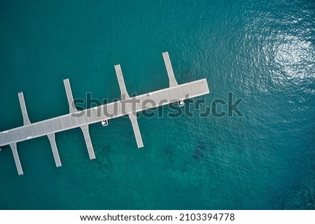 Flying drone over the marina floating dock Royalty-Free Stock Photo #2103394778
