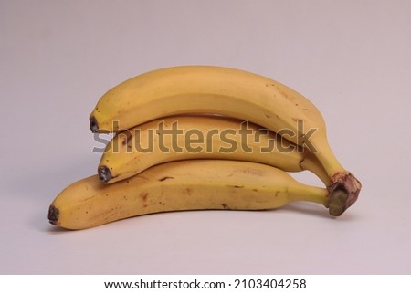 Three bananas on a white background.