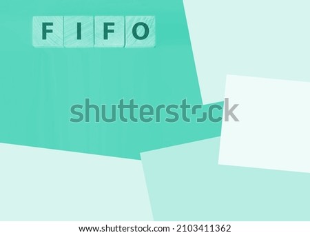 FIFO First in, first out word on wooden cubes on a blue background. Accounting, Business Concept image.