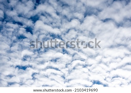 Background texture in the form of blue sky and white clouds.
