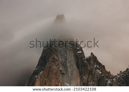 Mountain Peaking Through The Clouds - Chamonix, France