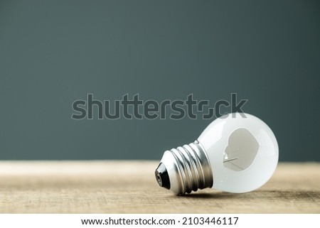 Small light bulb with a broken hole, concept for unsuccessful, problem or mistaken idea, misunderstanding to make a wrong decision Royalty-Free Stock Photo #2103446117
