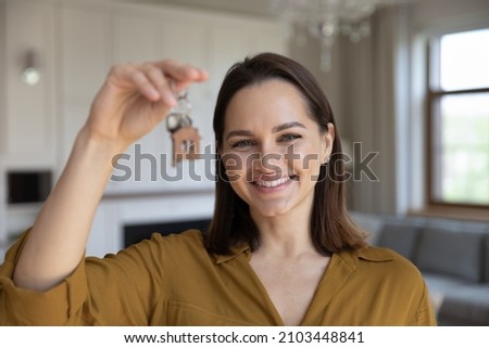 Happy cheerful real estate agent woman offering rent apartment, buying house, flat, help with mortgage, property deal. Female realtor showing, giving key from new home to buyer, renter, tenant