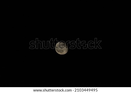 A picture of the moon in the middle of the sky. 
