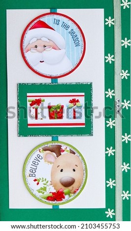 Christmas card with a picture of Santa Claus, a funny deer and gifts painted with a fabric ribbon and snowflakes