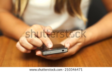 Closeup image on a female hands holding smartphone 