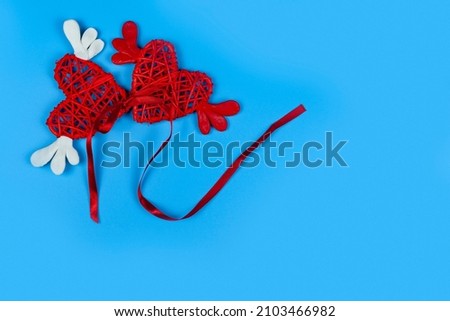 Hearts with wings on a blue background. Place for your text. Festive card for Valentine's Day.