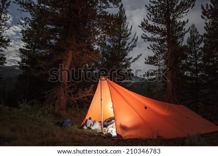 Camping in a lit up tent/tarp in the wilderness in Yosemite National Park