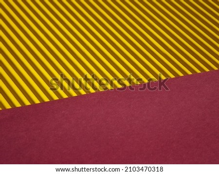 Background consisting of two parts : yellow corrugated surface and red. High quality photo