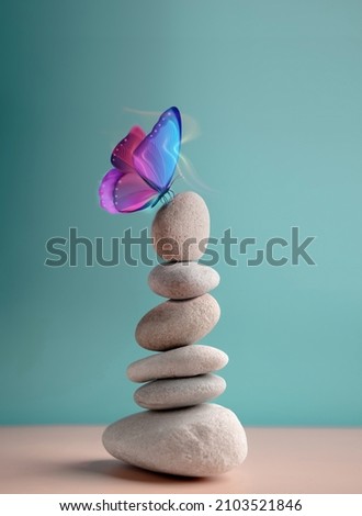 Harmony of Life Concept. Surrealist Butterfly on the Pebble Stone Stack. Metaphor of Balancing Nature and Technology. Calm, Mind, Life Relaxing and Living by Nature. Vertical image Royalty-Free Stock Photo #2103521846