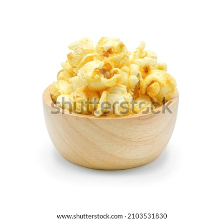 Caramel popcorn in wooden bowl isolated on white background.