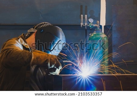 Welding of metal structures by semi-automatic arc welding. MIG MAG welding method. Royalty-Free Stock Photo #2103533357
