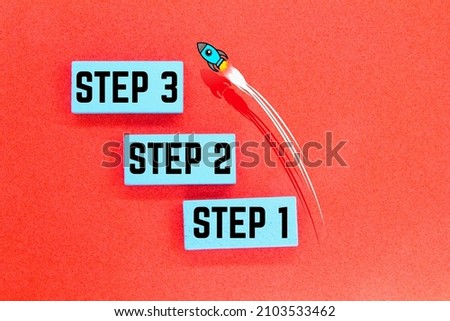 colored board with the words step 1, step 2 and step 3  Royalty-Free Stock Photo #2103533462