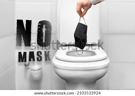 no mask - text about the end of the coronavirus pandemic. a person throws a protective mask into the toilet. stop the protest