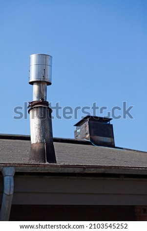 a strange chimney on the roof of a culture house 