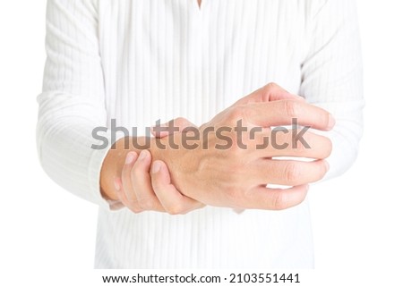 The man touches the wrist and thumb. He squeezes the knuckle of the thumb and wrist. He suffered a tendon injury, arthritis in his wrist, and de Quervain's disease.