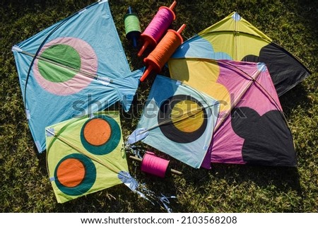 Sankranti kites patang flying outdoors. Colorful kites during kite festival. Makar sankranti festival celebrations. Kites on ground Royalty-Free Stock Photo #2103568208