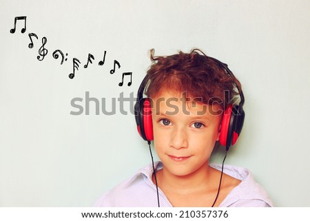  little kid with headphones  listening to music and notes sketches