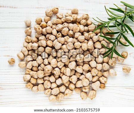 Uncooked dried chickpeas on a old wooden table