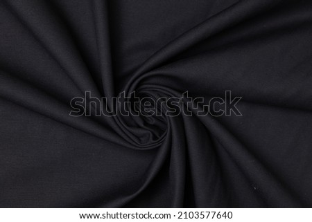 Swirled black color fabric texture background. This fabric is made from polyester. Royalty-Free Stock Photo #2103577640