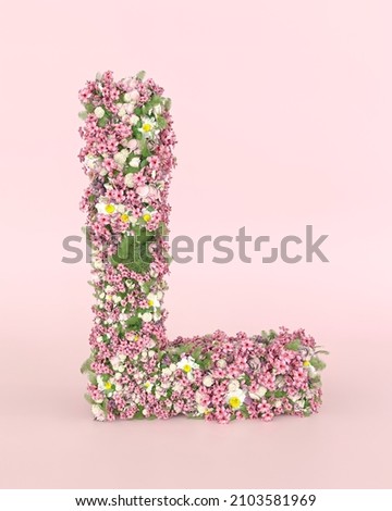 Creative letter L concept made of fresh Spring wedding flowers. Flower font concept on pastel pink background.