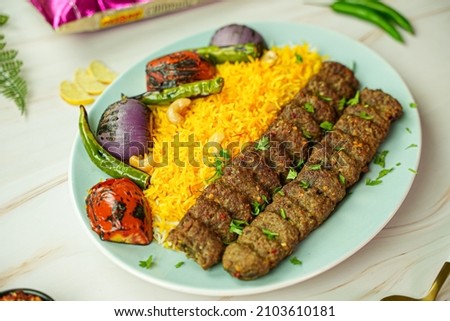 chelo kebab with rice and tomato chili and onion Royalty-Free Stock Photo #2103610181