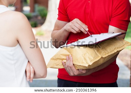 Close-up of a delivery man asking for a signature