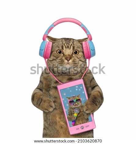 A beige cat listens to music on a pink smartphone. White background. Isolated.