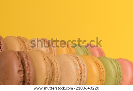 A pile of delicious Macaroons, French treats made of almonds with lime, pistachio and vanilla flavors