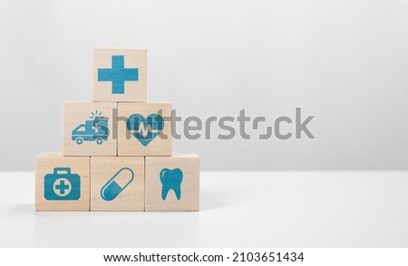 Medical icon on pyramid of cubes. medicine and health insurance concepts. Wooden blocks with icons of various types of insurance, icons healthcare medical symbol on wooden block Royalty-Free Stock Photo #2103651434