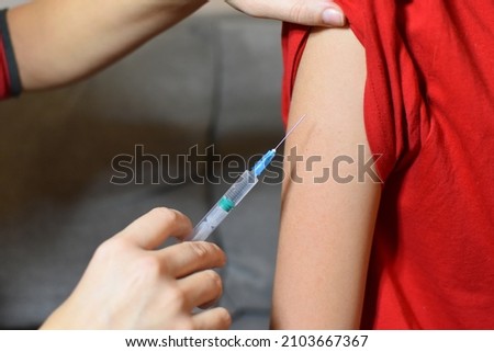 vaccination of the child. the doctor gives an injection in the arm