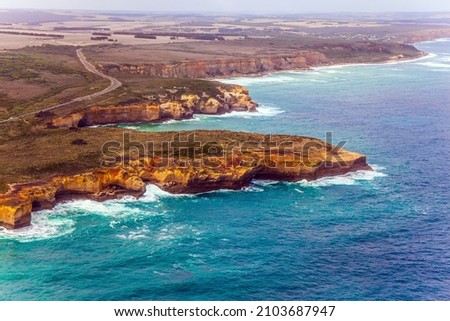 Great Ocean Road and coastal cliffs of the Twelve Apostles is a group of limestone cliffs. Australia, Port Campbell National Park. Picture taken from a helicopter  
