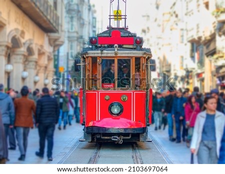 Nostalgic retro red tram on famous Istiklal street. Istiklal Street is a popular tourist destination in Istanbul. Royalty-Free Stock Photo #2103697064