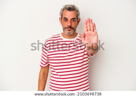 Middle age caucasian man isolated on white background  standing with outstretched hand showing stop sign, preventing you.