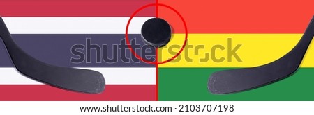 Top view hockey puck with Thailand vs. Bolivia command with the sticks on the flag. Concept hockey competitions