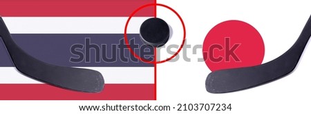 Top view hockey puck with Thailand vs. Japan command with the sticks on the flag. Concept hockey competitions