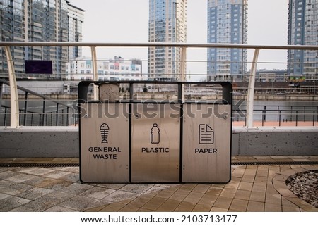 4 Colors metal stainless steel recycle bins and trash bin with icons. Office waste management. Keep environment clean design concept image with empty space for text. High quality photo Royalty-Free Stock Photo #2103713477