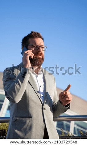 handsome businessman with phone in the city