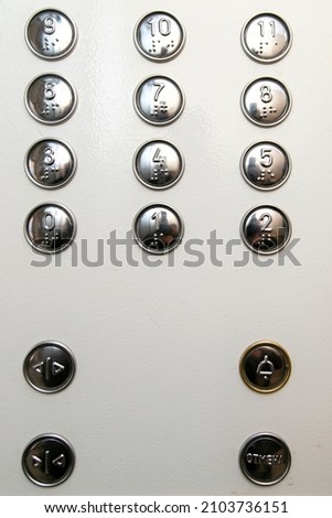 Metal buttons with numbering on the elevator panel.
