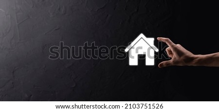Real estate concept, businessman holding a house icon.House on Hand.Property insurance and security concept. Protecting gesture of man and symbol of house.
