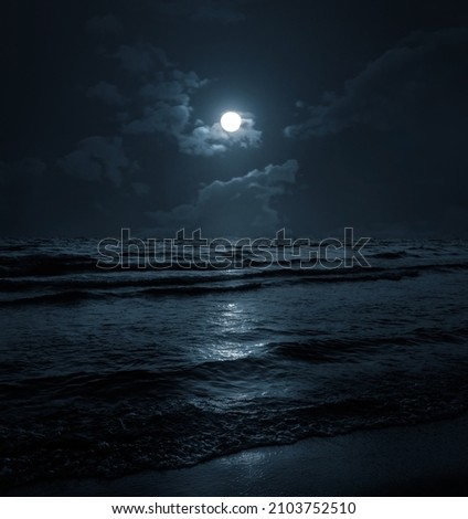 Moon over blue sea or ocean. Night view. A good background for the theme of travel, vacation, voyage. Royalty-Free Stock Photo #2103752510