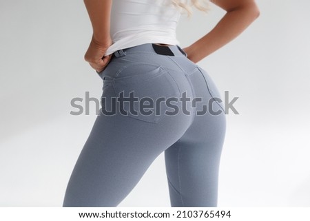 Fitness model in leggings with beautiful buttocks. Sporty booty Royalty-Free Stock Photo #2103765494