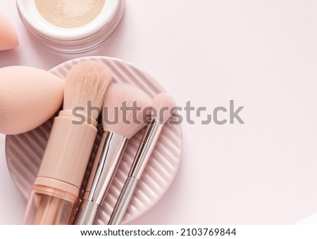 Makeup accessories, brushes and sponges,pink pastel background,flat layot Royalty-Free Stock Photo #2103769844