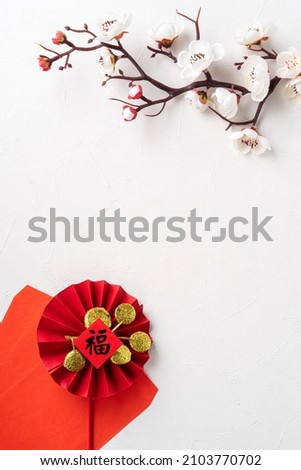Top view of Chinese lunar new year background copy space design concept with white plum flower and festive decoration, the word inside picture means blessing.