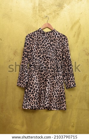 female in fashion leopard print seamless pattern sundress on hanger-brown background 