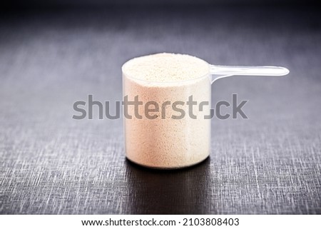 measuring spoon with casein and creatine, powdered food supplements, protein or amino acid used by athletes Royalty-Free Stock Photo #2103808403