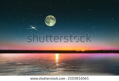 big moon blue bright starry sky on pink yellow sunset at sea water vawe reflection blurred light full moon moonlight  skyline  nebula nature background 