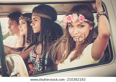 Multi-ethnic hippie friends in a minivan on a road trip Royalty-Free Stock Photo #210382183