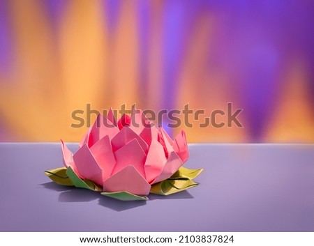 lotus flower origami on yellow and pink background
