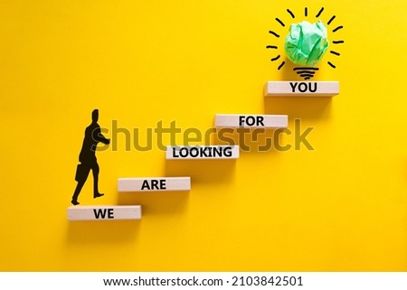 We are looking for you symbol. Wooden blocks with words We are looking for you. Beautiful yellow background, copy space. Businessman icon, light bulb. Business, we are looking for you concept.